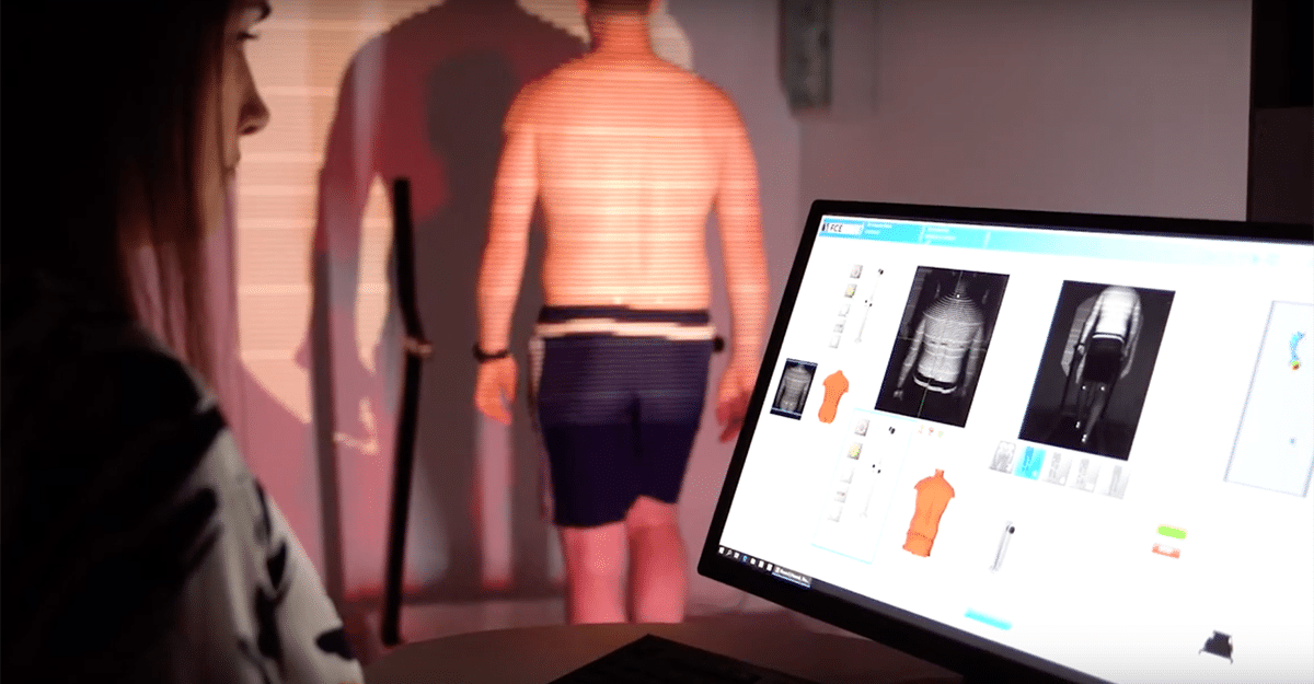 A person observes a virtual model displayed on a computer screen, which appears to be part of an FCE Scan design or fitting process. | FCE Scan