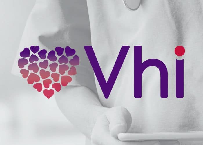 A healthcare professional in a white coat with a stethoscope, partially visible, next to the logo of "vhi" accompanied by a graphic of a heart made up of smaller hearts in shades of. | FCE Scan